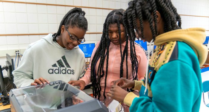 Students using a 3D printer.