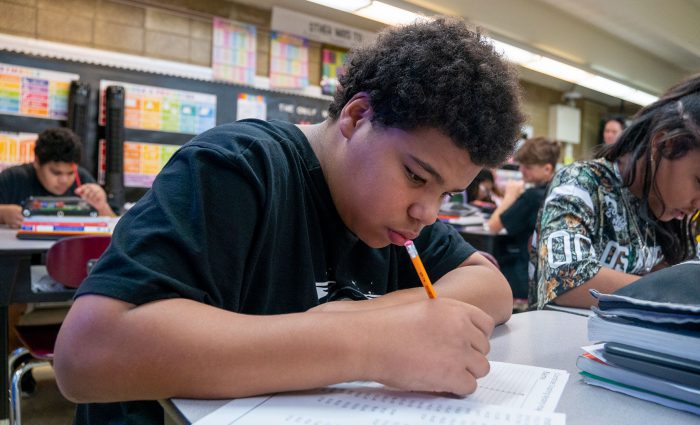 Students in a classroom working on an assignment.