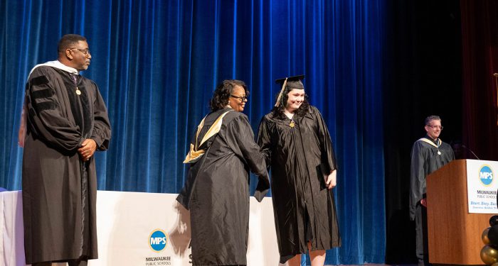 A student receives her diploma.