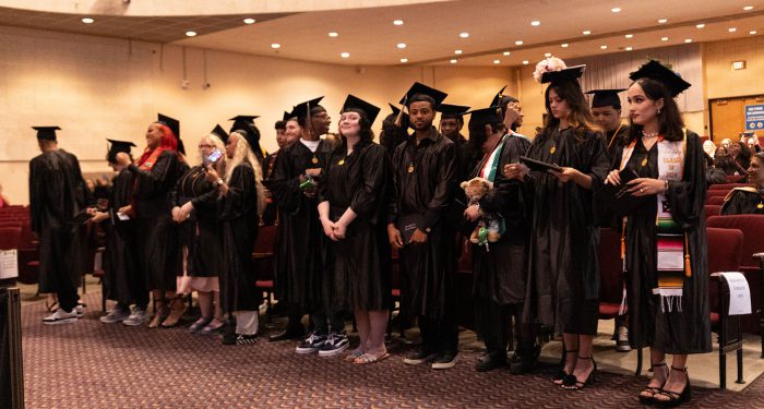 Graduates standing in a row.
