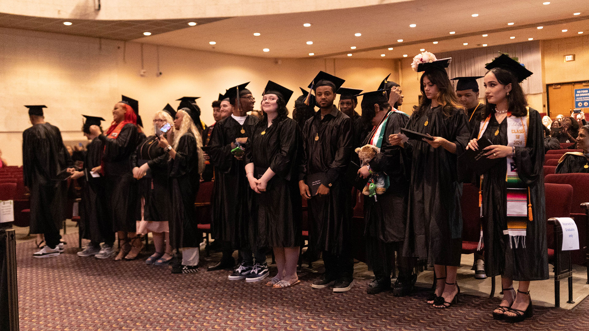 Graduates standing in a row.