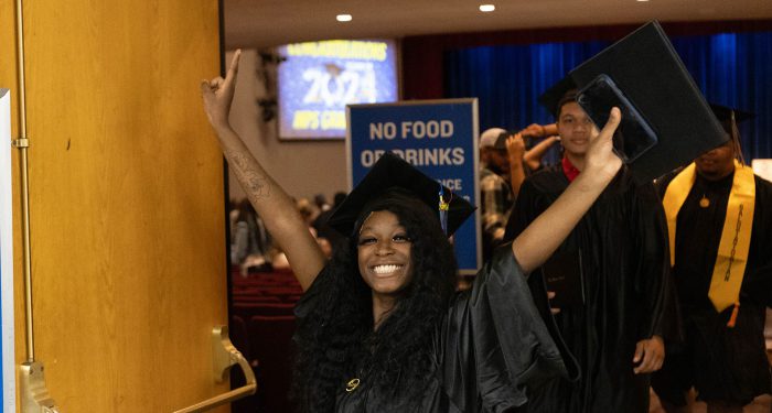 A graduate celebrates after the ceremony.