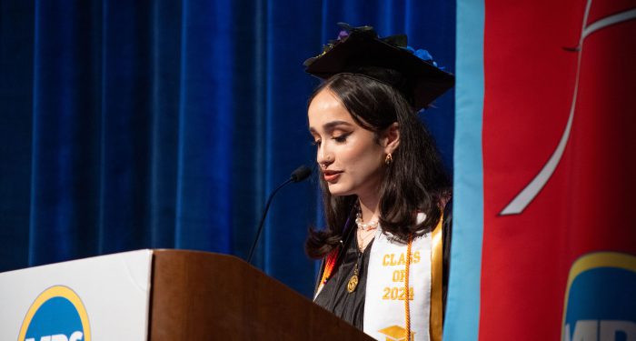 A graduate at a podium.