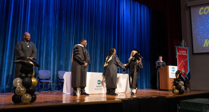 A student receives her diploma.
