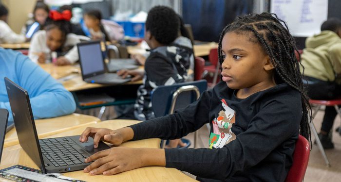 Children in a classroom using computers.