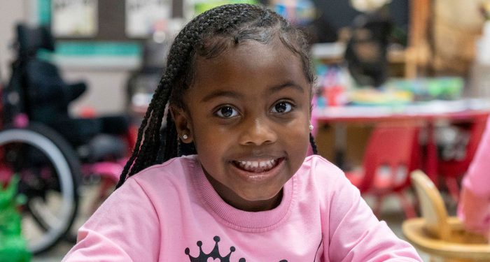 Close-up of a young girl smiling.