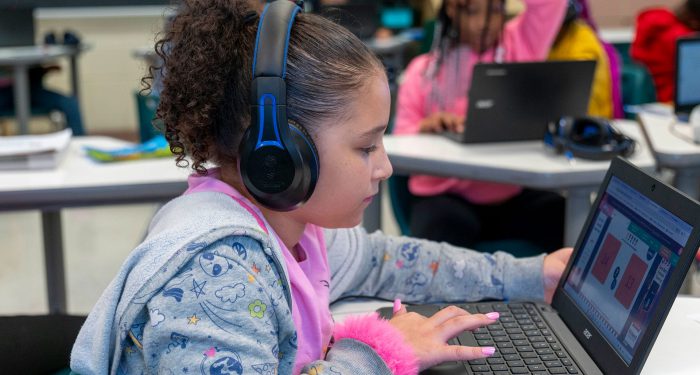 A child playing a math game on a laptop.