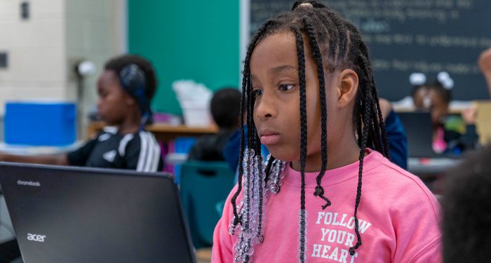 A child looking at a computer screen.