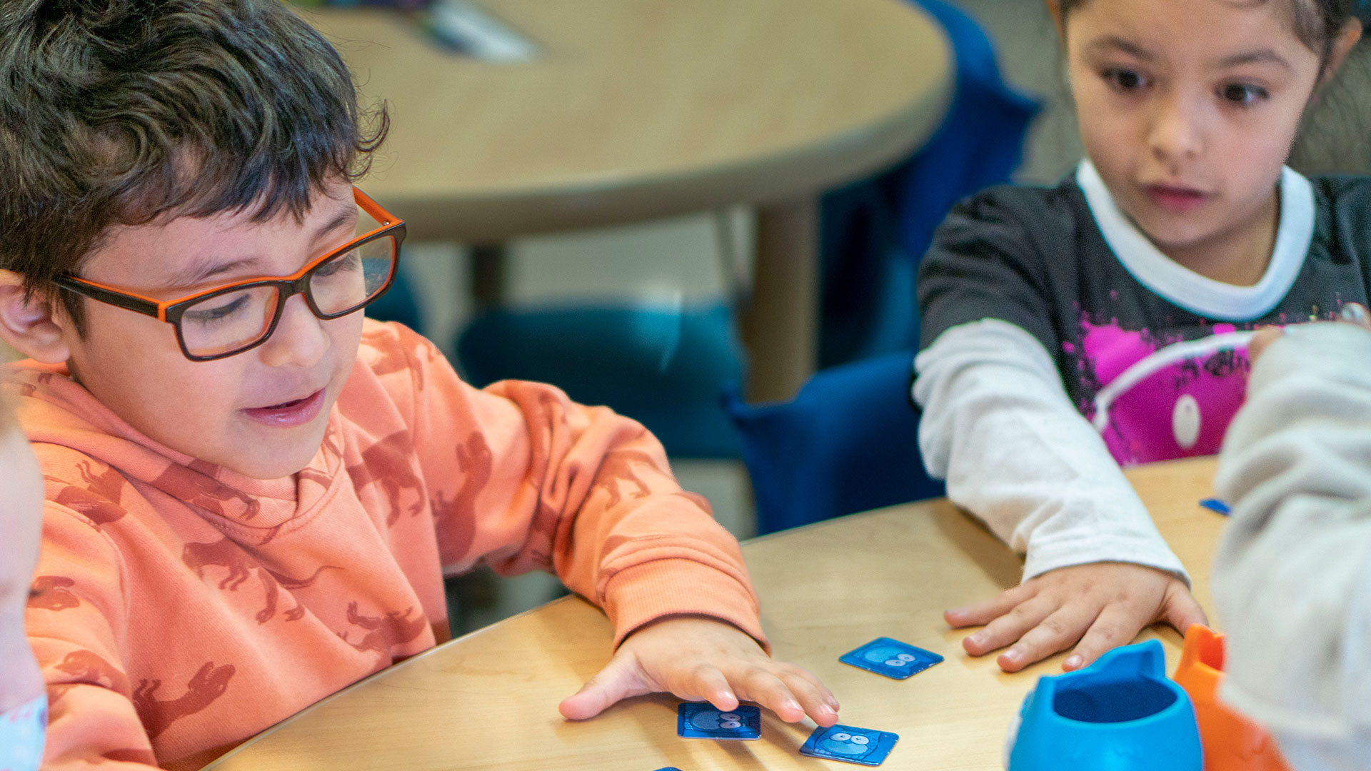 Young students playing a game with cards.