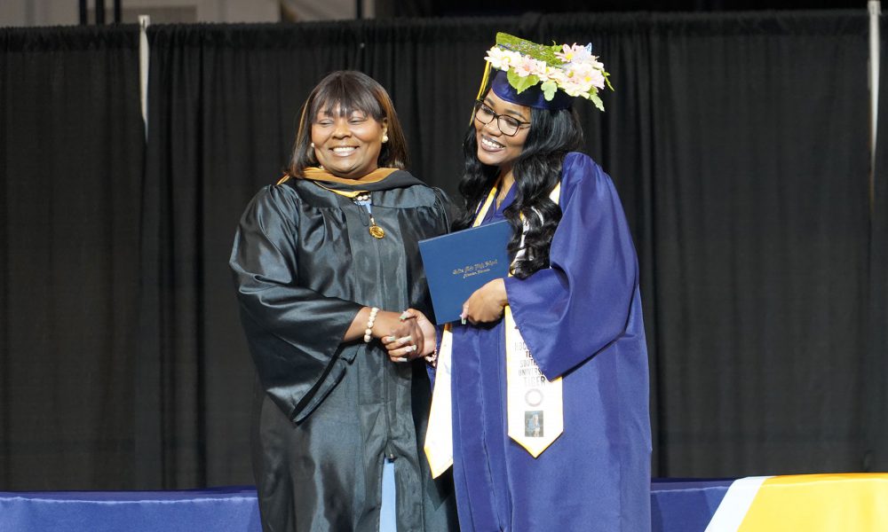 A graduate receives their diploma.