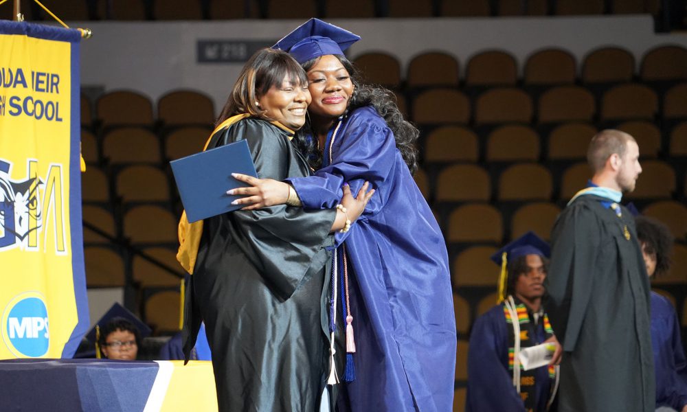 A graduate receives their diploma.