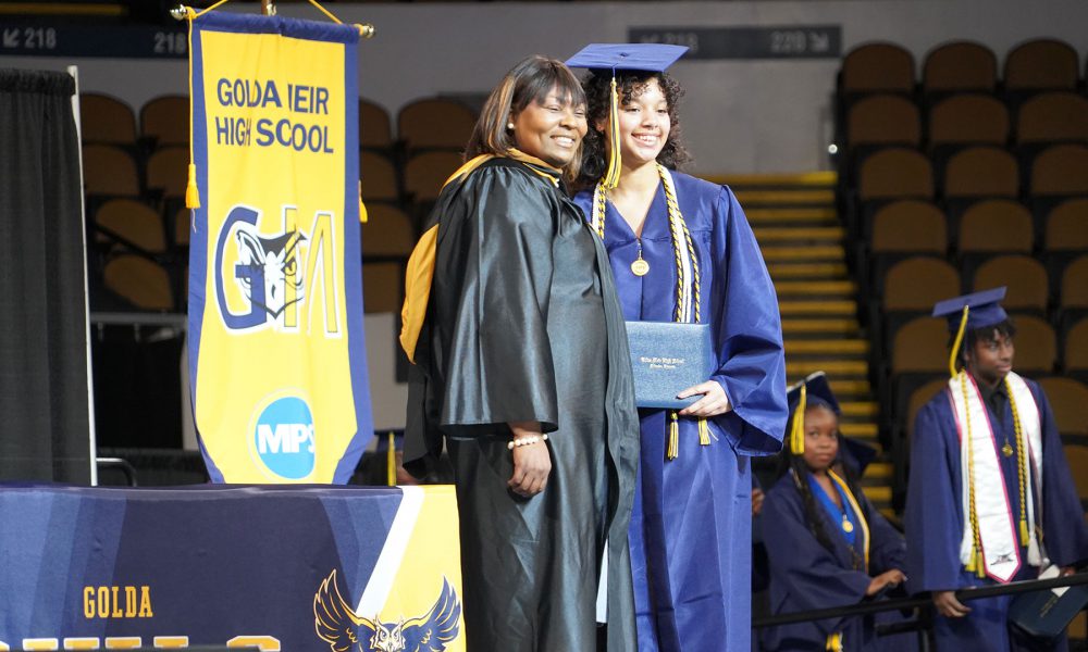 A graduate receives their diploma.