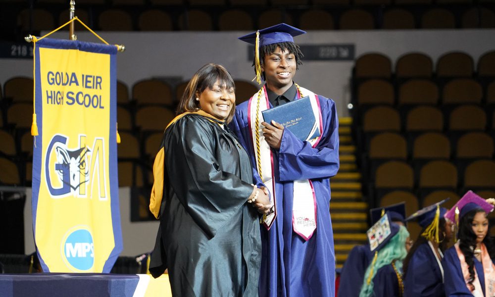 A graduate receives their diploma.