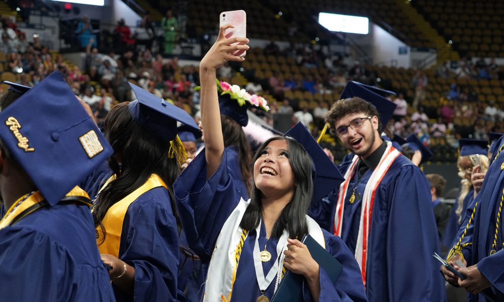 Graduates taking selfies.