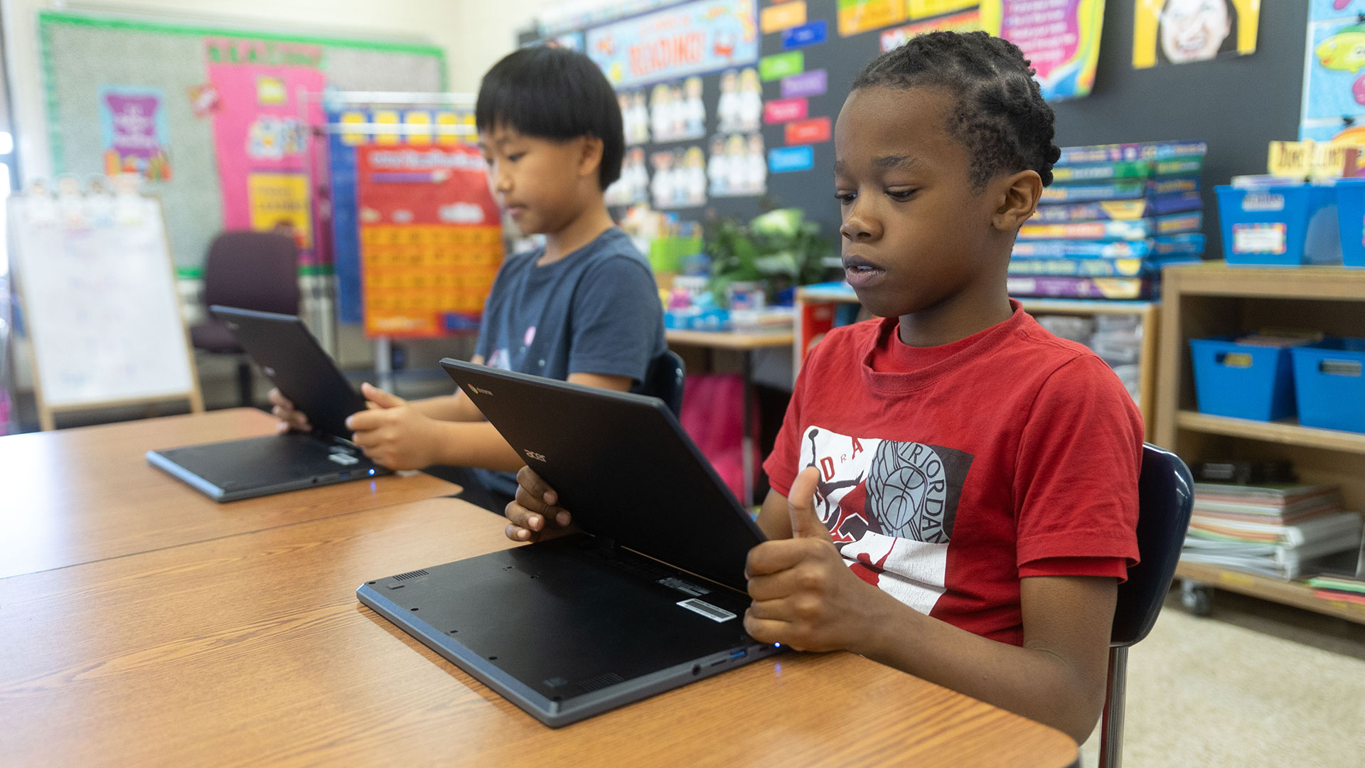Two students using laptops.