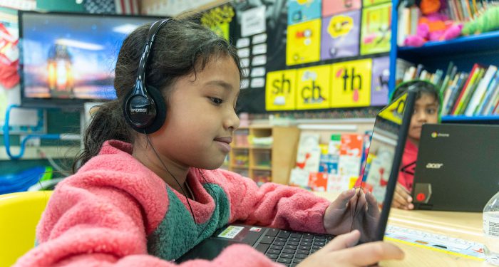 Children in a classroom using computers.