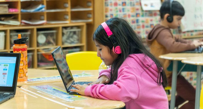 Children in a classroom using computers.