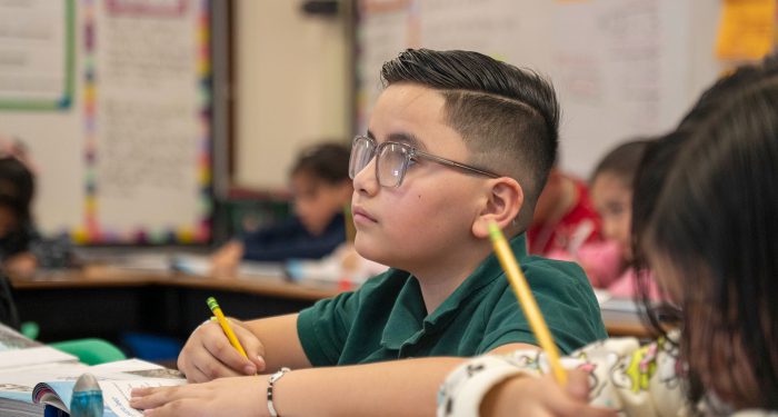 A child paying attention in a classroom.