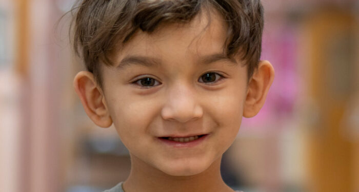 Close-up of a smiling young boy.