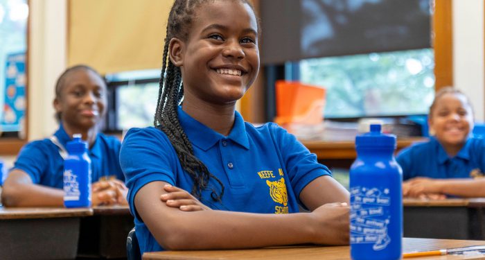 A classroom of smiling girls.