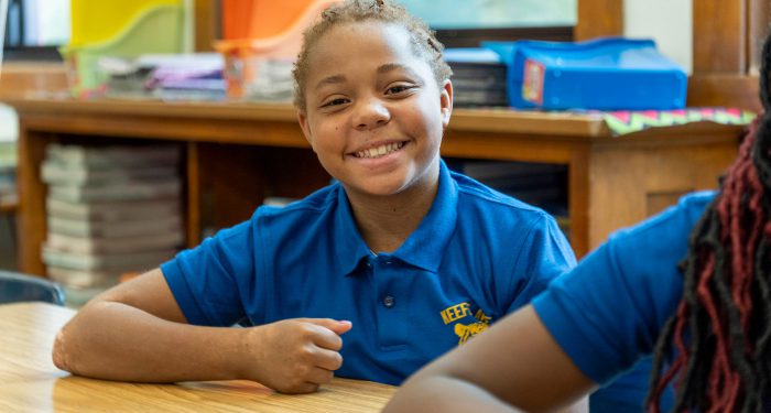 A smiling girl in classroom.