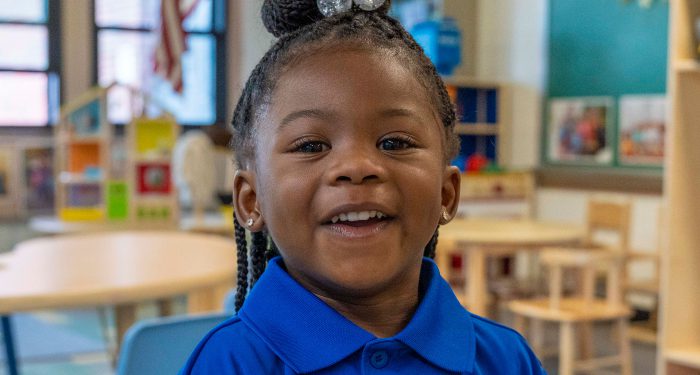 Close up of a young girl smiling.