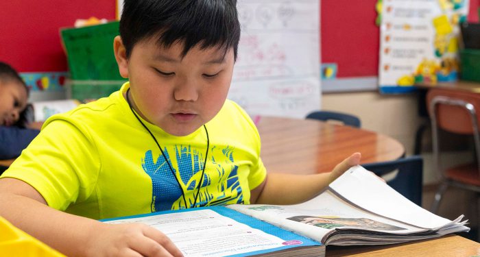 A student reading a workbook.