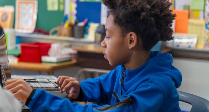 A student using a computer.