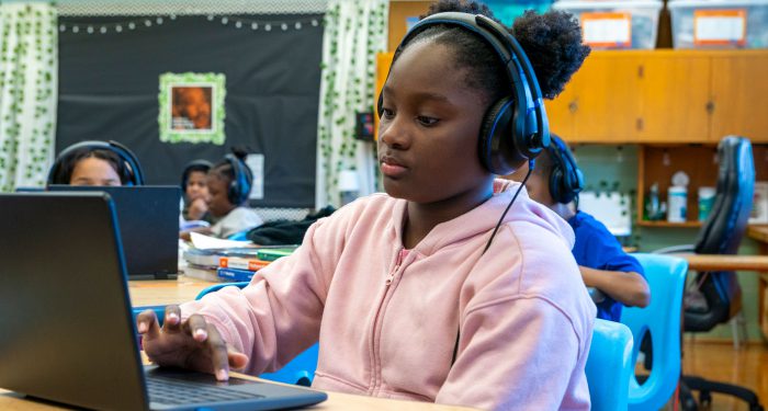 Students in a classroom using computers.