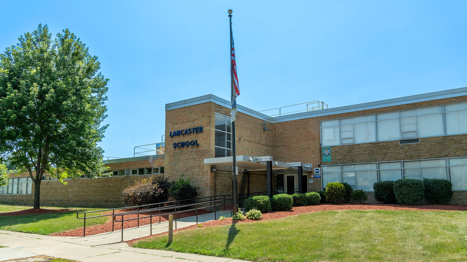 Exterior of Lancaster School on a sunny day.