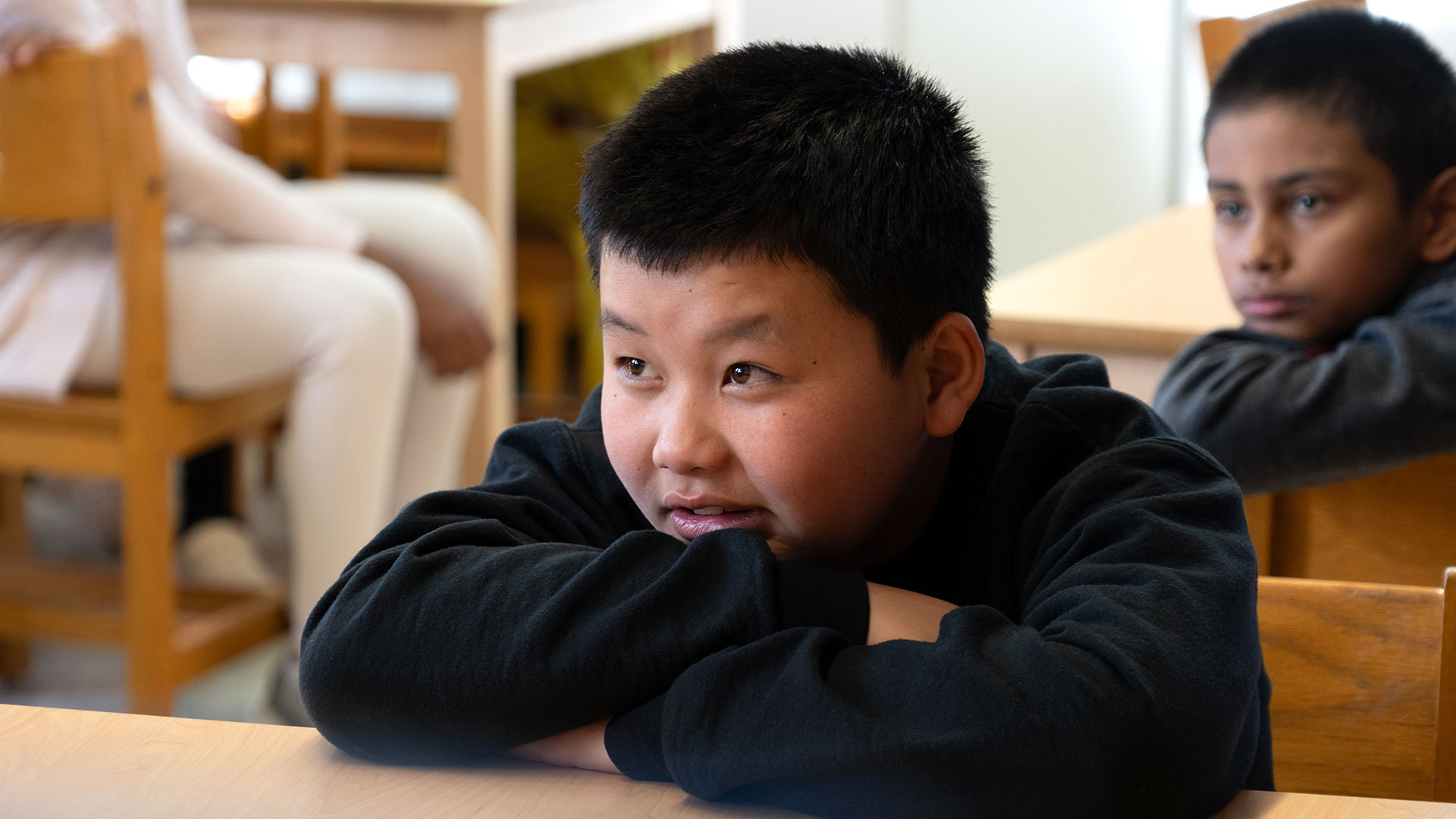 Focused children sitting at desks.