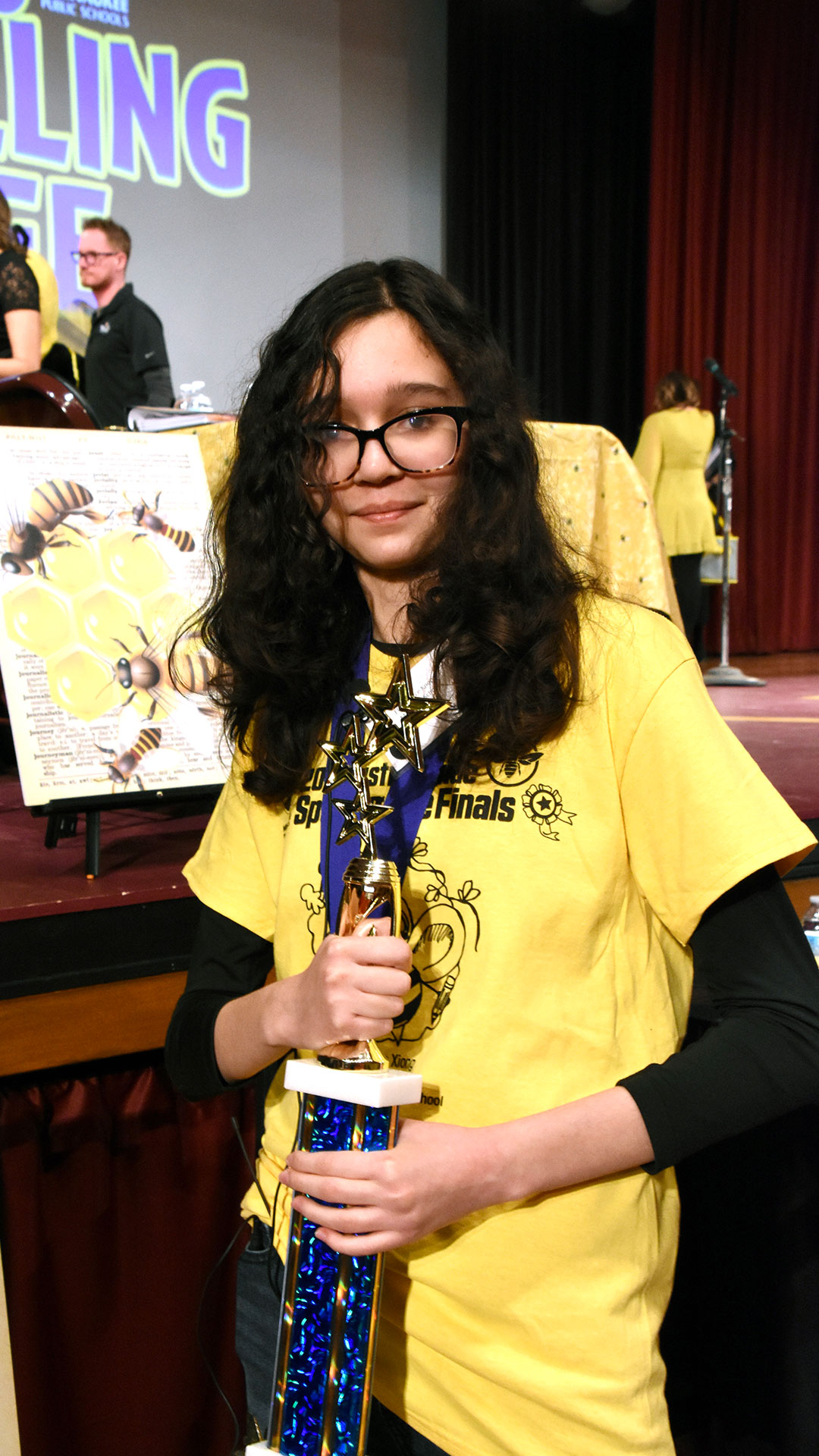 Ellen holding her trophy.