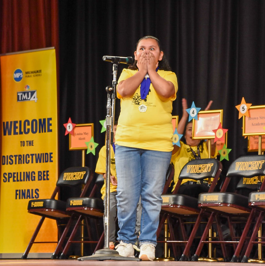 Sophia at the microphone looking shocked.