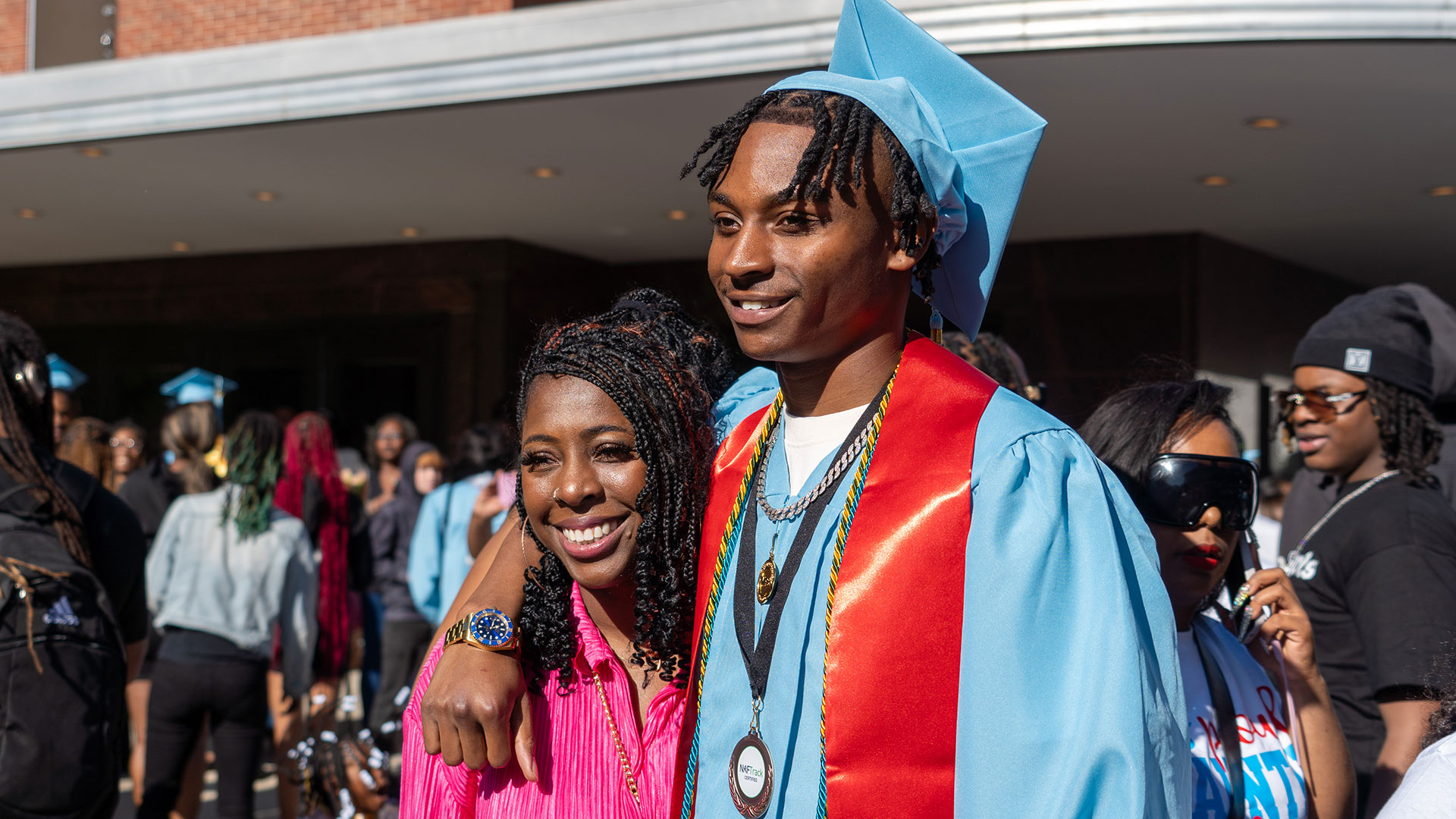 Graduates celebrate outside after the ceremony with their families.