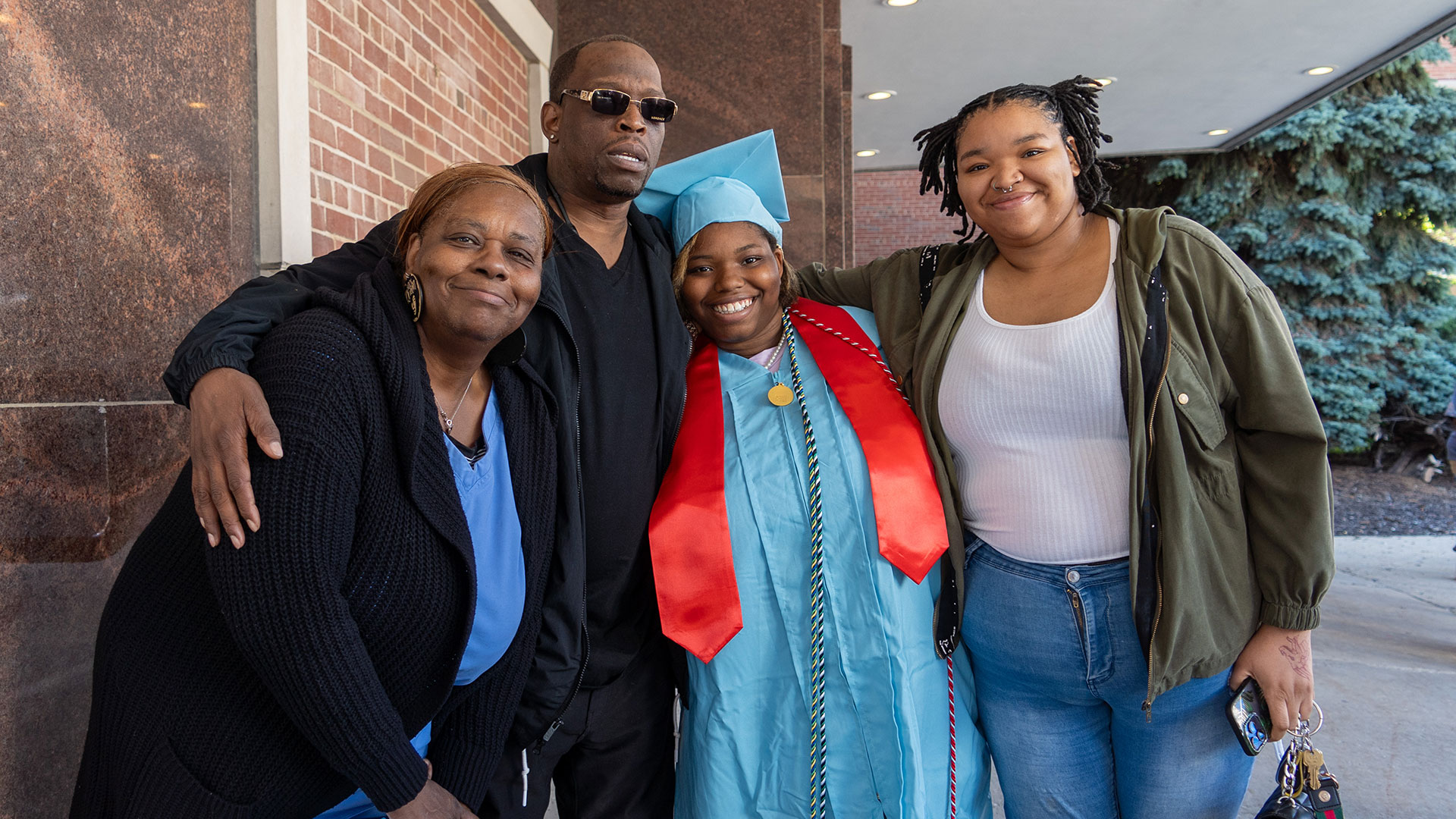 Graduates celebrate outside after the ceremony with their families.