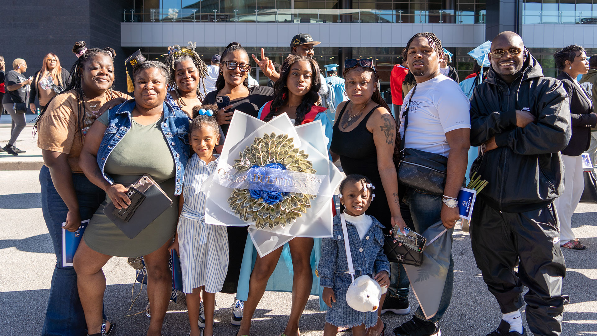 Graduates celebrate outside after the ceremony with their families.