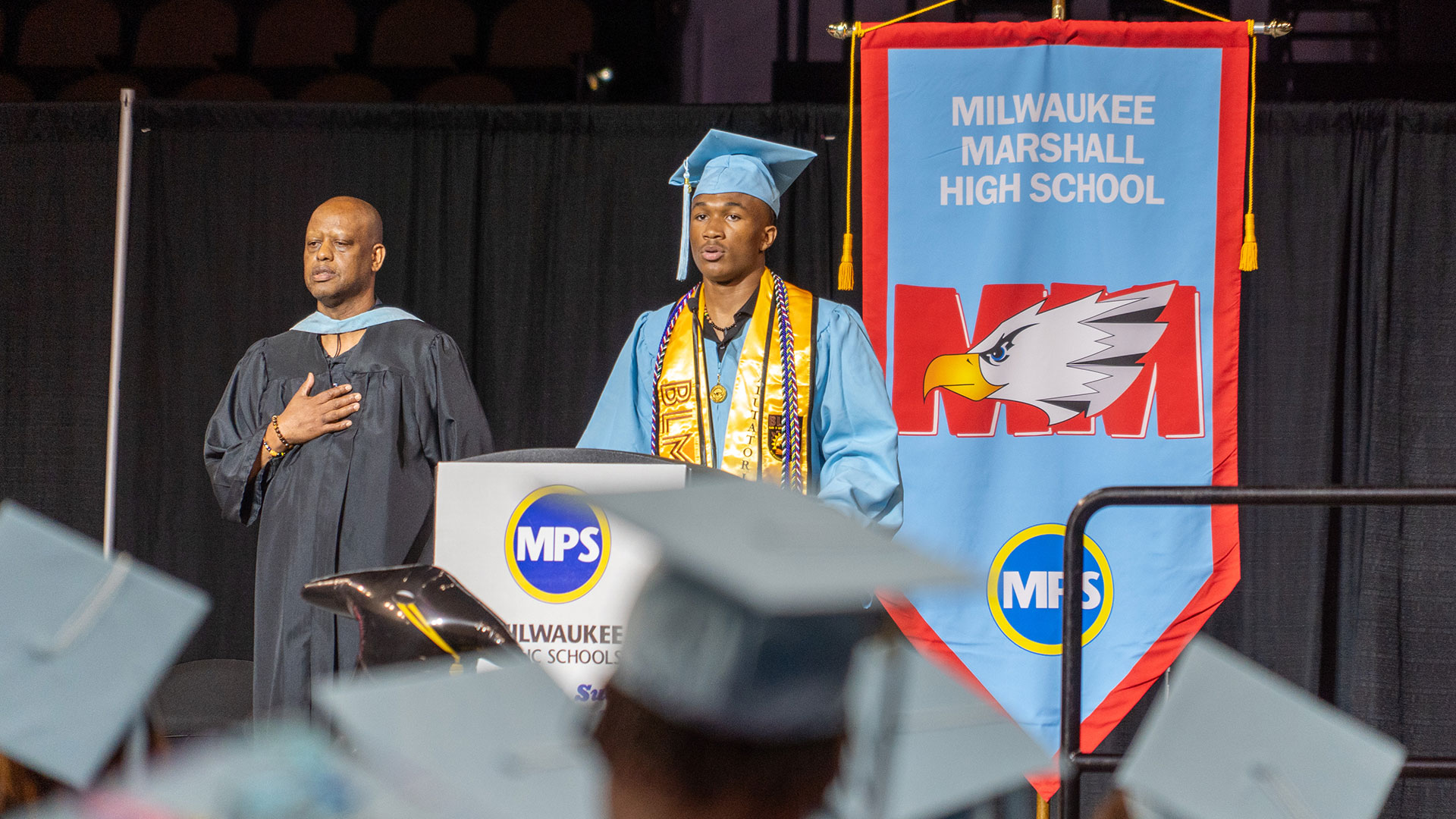 A graduate recites the Pledge of Allegiance.
