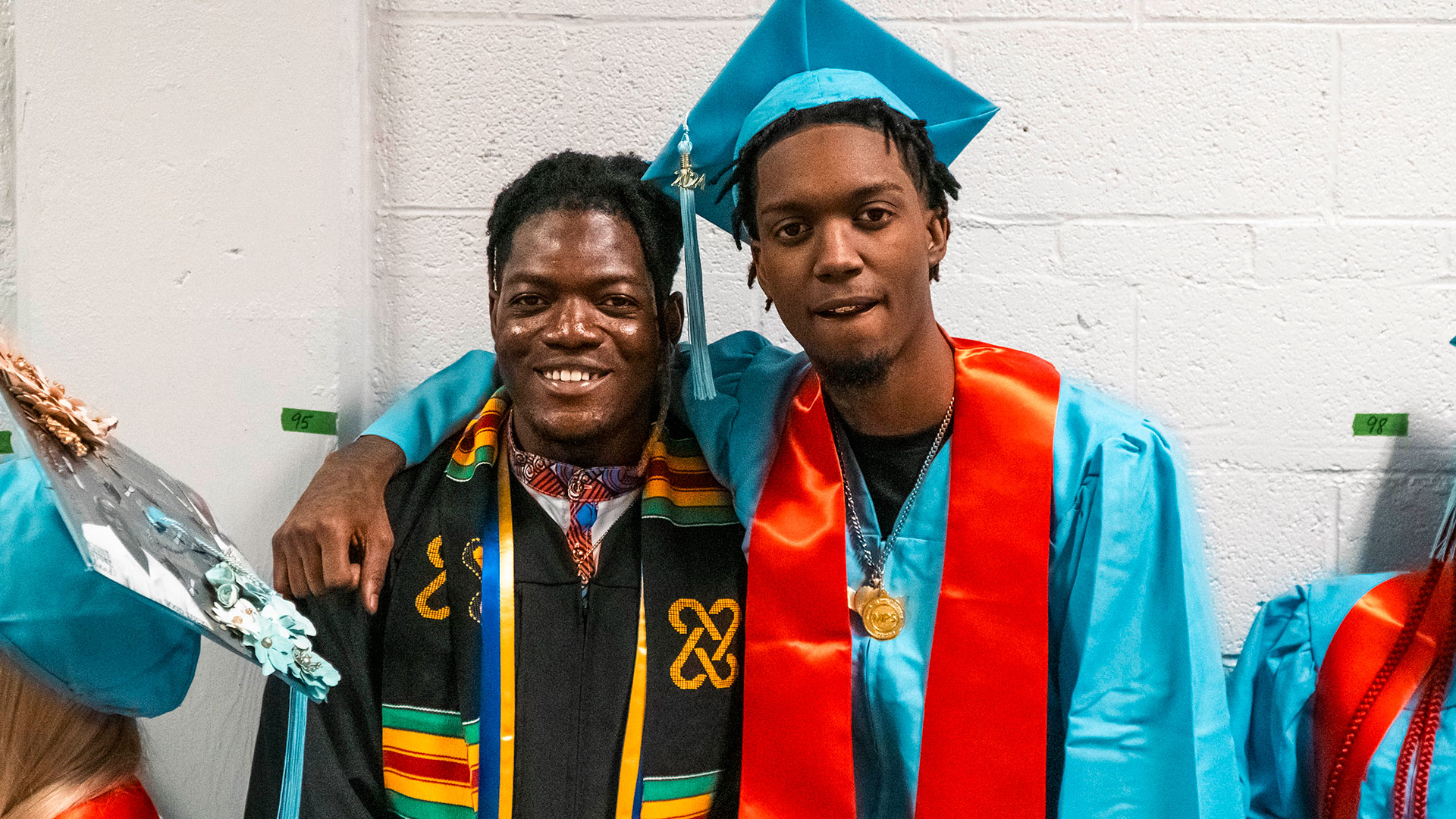 Graduates and staff in the hallway before the ceremony.