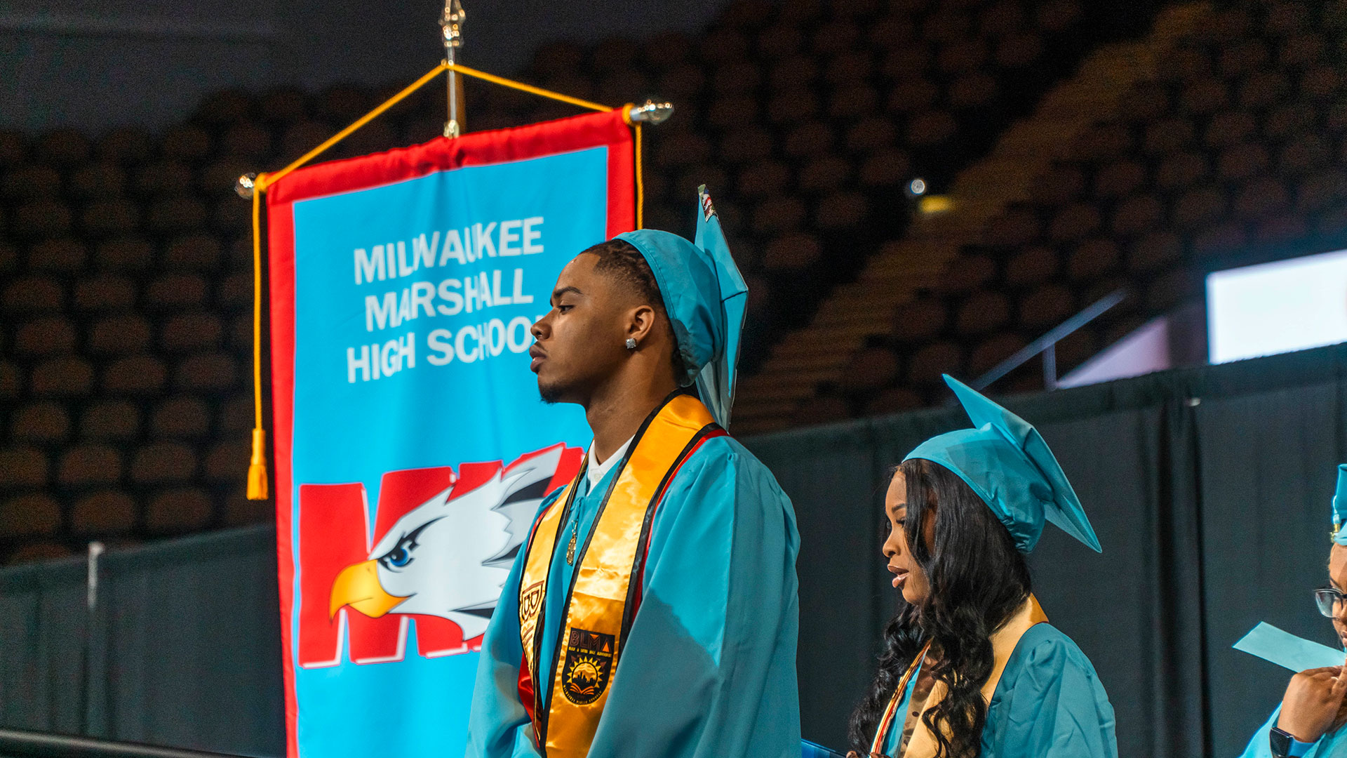 Graduates line up to receive their diplomas.