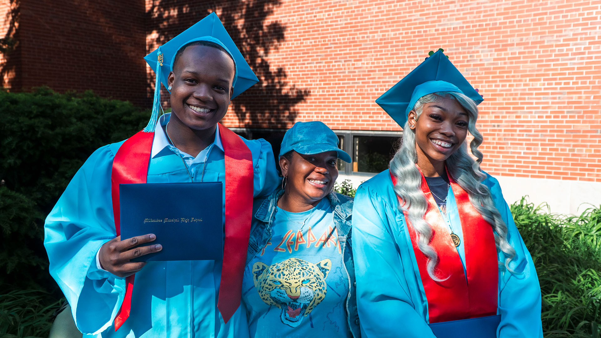 Graduates celebrate outside after the ceremony with their families.