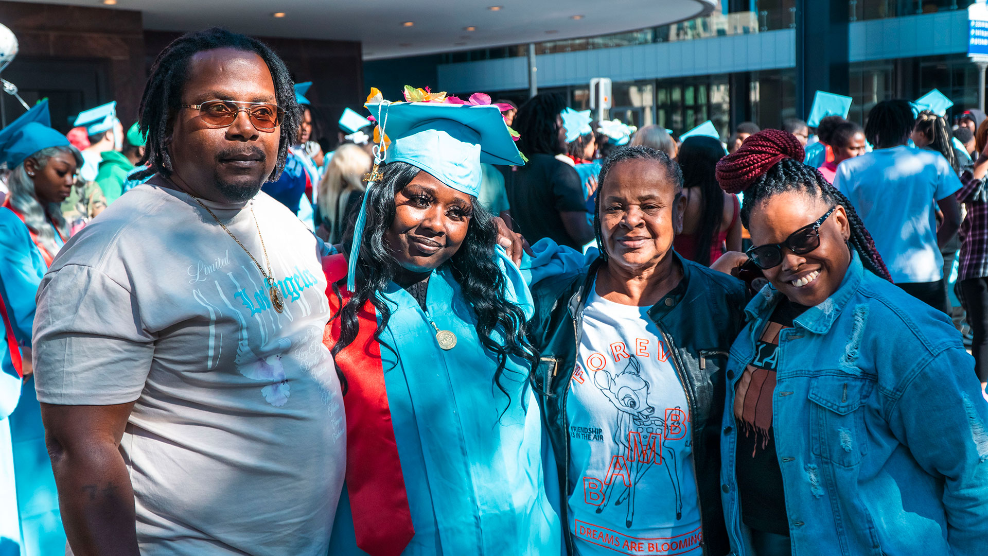 Graduates celebrate outside after the ceremony with their families.