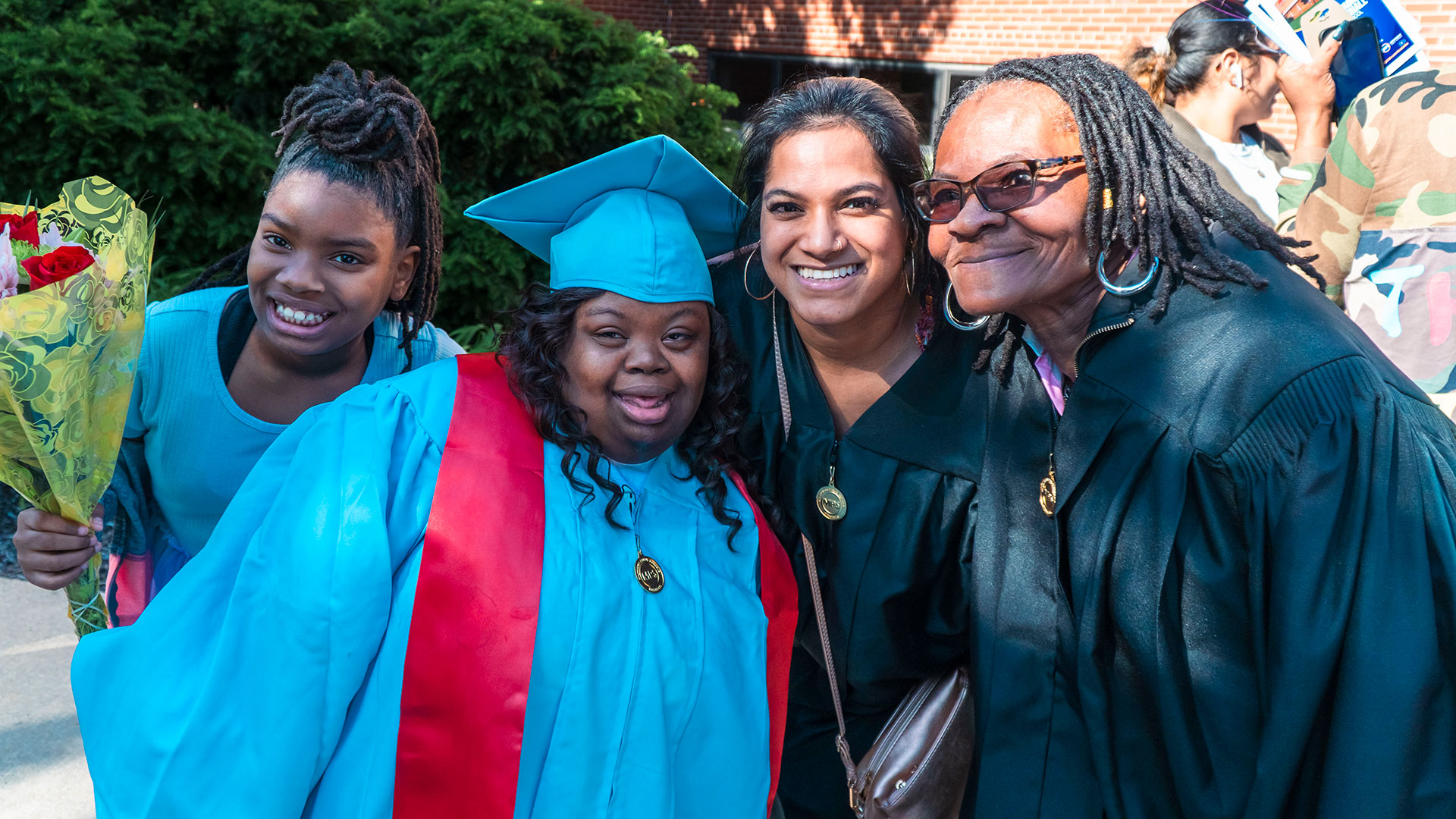 Graduates celebrate outside after the ceremony with their families.