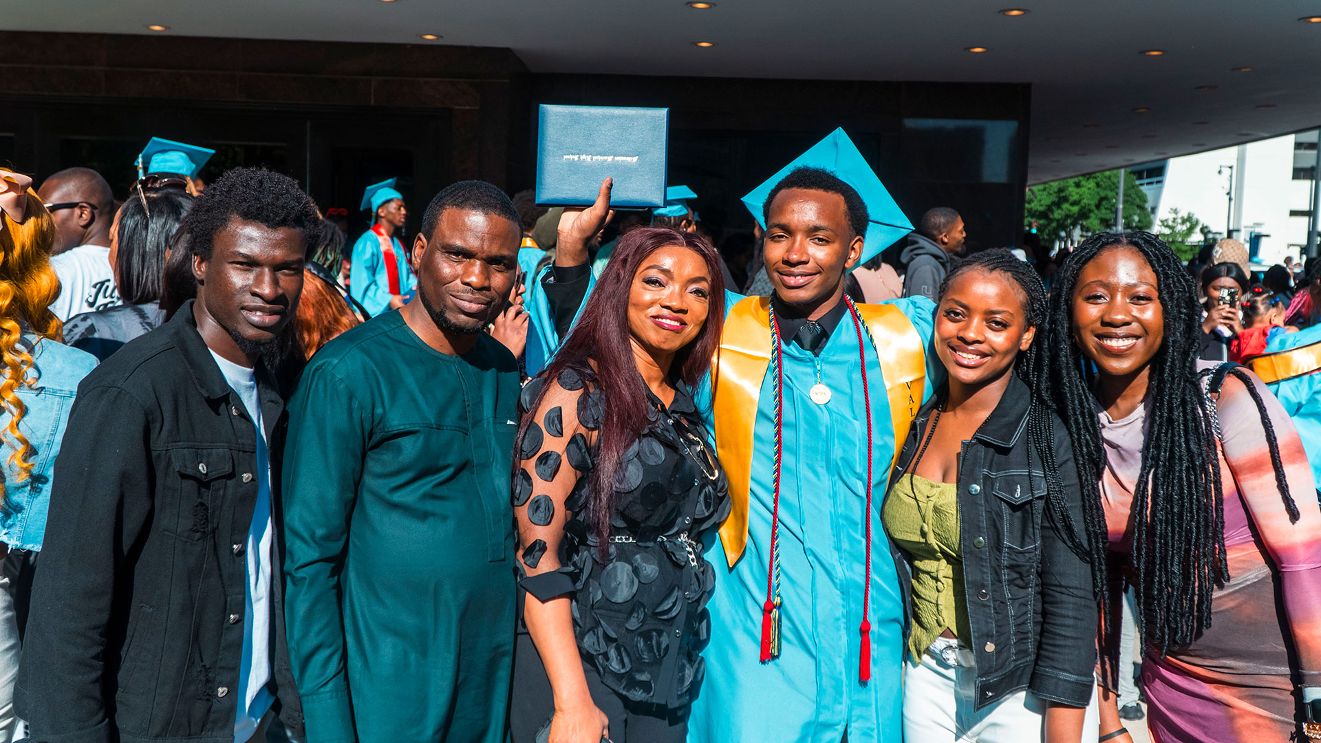 Graduates celebrate outside after the ceremony with their families.