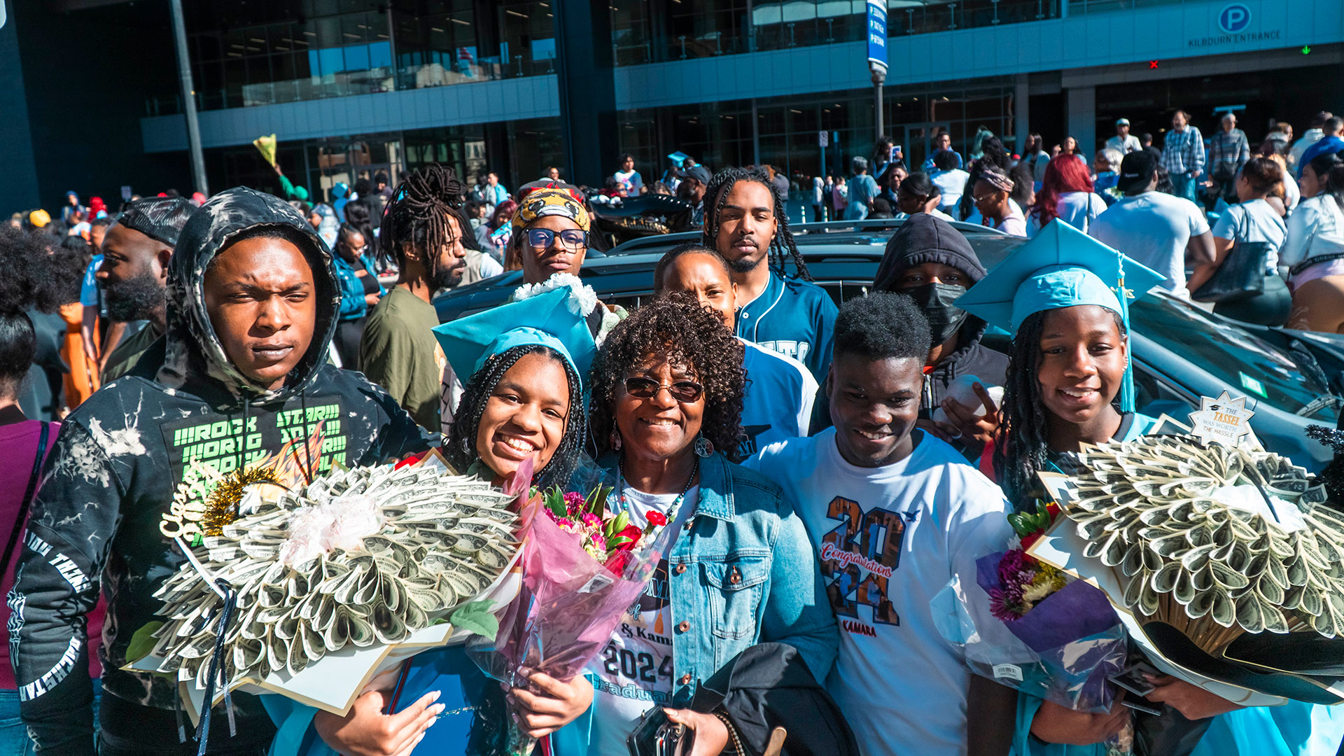 Graduates celebrate outside after the ceremony with their families.