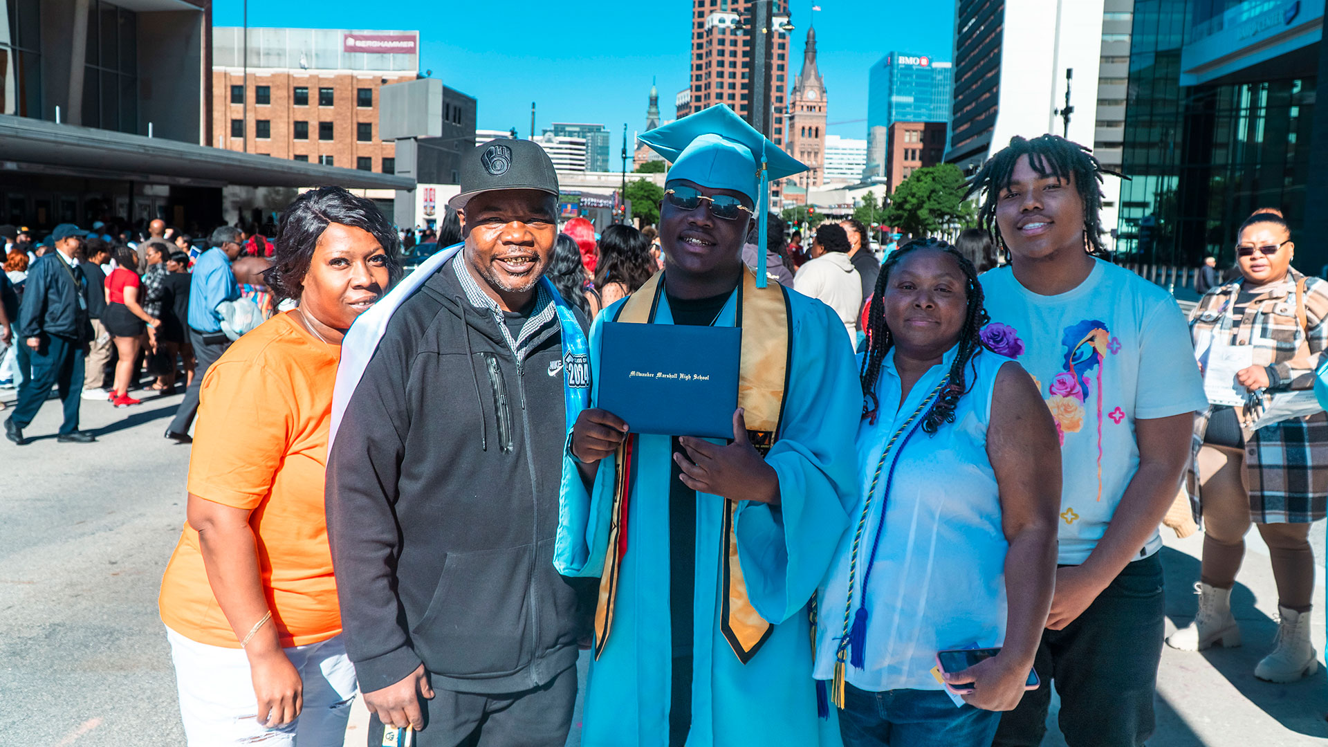 Graduates celebrate outside after the ceremony with their families.