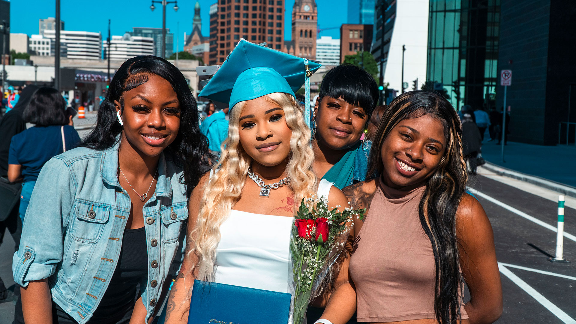 Graduates celebrate outside after the ceremony with their families.