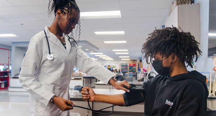Students practice taking blood pressure.