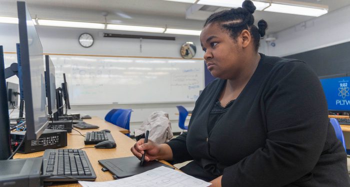 A student using a computer.