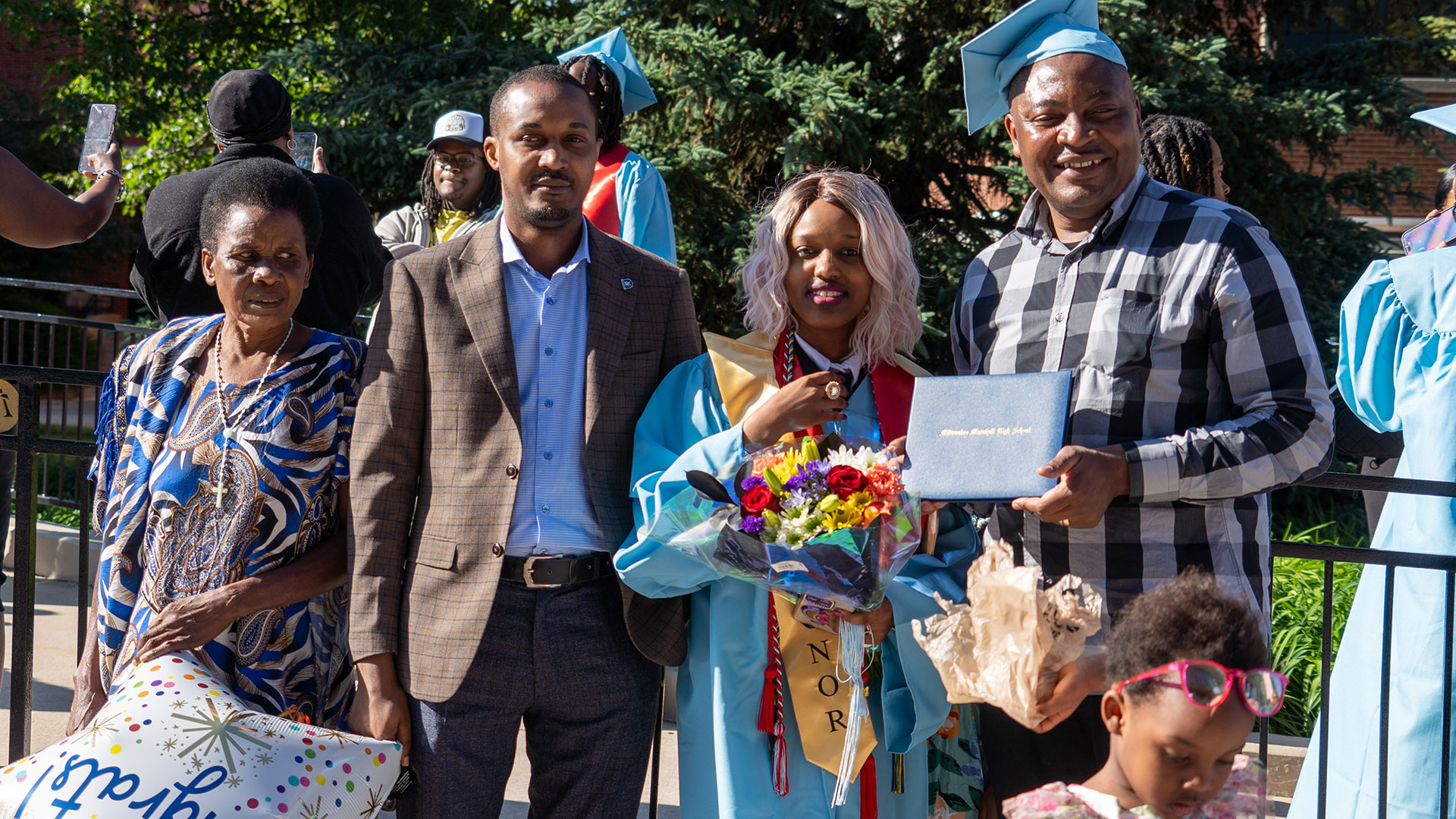 Graduates celebrate outside after the ceremony with their families.