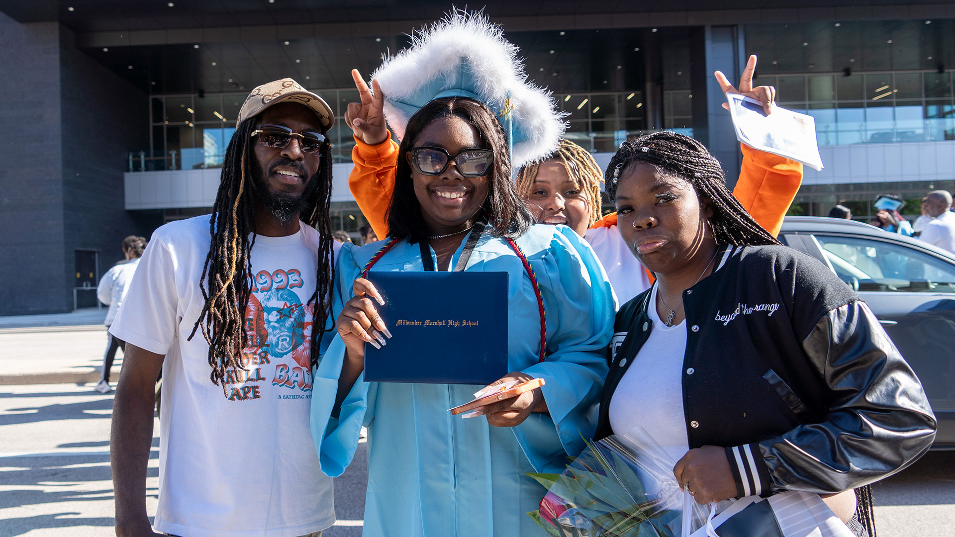 Graduates celebrate outside after the ceremony with their families.